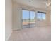 Bright bedroom with neutral carpet and a large sliding glass door to the outside at 1870 E Indigo Dr, Chandler, AZ 85286