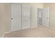 Bedroom features a neutral carpet, a closet with sliding doors, and neutral paint at 1870 E Indigo Dr, Chandler, AZ 85286