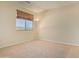 A light filled bedroom with a large window and a sleek floor lamp at 1870 E Indigo Dr, Chandler, AZ 85286