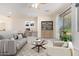 Staged bonus room includes sofa, chair, bookcase, desk, and access to balcony at 1870 E Indigo Dr, Chandler, AZ 85286