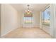 Open dining area with neutral walls, tile flooring, natural light from large windows and modern light fixture at 1870 E Indigo Dr, Chandler, AZ 85286