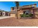 Two-story home featuring desert landscaping, a three-car garage, and a stone-accented facade at 1870 E Indigo Dr, Chandler, AZ 85286