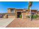 Charming two-story home featuring a stone facade, well-manicured landscaping, and a spacious driveway at 1870 E Indigo Dr, Chandler, AZ 85286