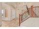 Grand foyer featuring high ceilings, tiled flooring, and a staircase with wood railings at 1870 E Indigo Dr, Chandler, AZ 85286