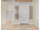 Bright foyer with neutral paint, tiled flooring, and transom windows above the front door at 1870 E Indigo Dr, Chandler, AZ 85286