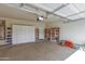 A spacious garage with built-in storage cabinets and concrete flooring at 1870 E Indigo Dr, Chandler, AZ 85286