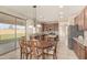 Bright eat-in kitchen with dark wood cabinets, stainless appliances, and sliding glass doors at 1870 E Indigo Dr, Chandler, AZ 85286