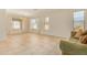 Bright and airy living room with neutral walls, tile flooring, and large windows at 1870 E Indigo Dr, Chandler, AZ 85286