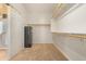 Spacious walk-in closet offering ample storage with installed shelving and carpeted floors at 1870 E Indigo Dr, Chandler, AZ 85286