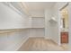 Large walk-in closet offering multiple storage shelves and bar, with adjacent bathroom at 1870 E Indigo Dr, Chandler, AZ 85286