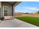 Outdoor living space with artificial turf, patio seating, and a wooden swing set at 19726 E Vallejo St, Queen Creek, AZ 85142