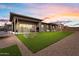Backyard view showcasing well-maintained artificial turf, gravel landscaping, and outdoor recreational equipment at 19726 E Vallejo St, Queen Creek, AZ 85142