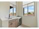 Wet bar featuring a marble countertop, cabinets, drawers, a wine fridge, and two windows with shades at 19726 E Vallejo St, Queen Creek, AZ 85142