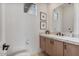 Stylish powder room boasts marble countertops, wood cabinetry, and modern fixtures at 19726 E Vallejo St, Queen Creek, AZ 85142