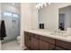 Modern bathroom featuring a large vanity, sleek fixtures, and a glass enclosed shower at 19726 E Vallejo St, Queen Creek, AZ 85142