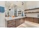 Elegant bathroom features a large mirror, floating shelves, and a vanity with marble countertops at 19726 E Vallejo St, Queen Creek, AZ 85142