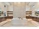 Luxurious bathroom with a soaking tub as its center piece and marble floors at 19726 E Vallejo St, Queen Creek, AZ 85142