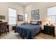 Comfortable bedroom featuring natural light, stylish decor, and wood-look floors at 19726 E Vallejo St, Queen Creek, AZ 85142