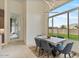 Bright dining area features a contemporary table setting with a view of the landscaped backyard at 19726 E Vallejo St, Queen Creek, AZ 85142