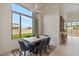 Open dining room with sleek table, ample natural light from a large window, and backyard views at 19726 E Vallejo St, Queen Creek, AZ 85142
