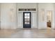 An elegant entrance foyer features a modern front door with sidelights and transom window at 19726 E Vallejo St, Queen Creek, AZ 85142