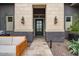 Elegant front door framed by stone pillars and outdoor sconces at 19726 E Vallejo St, Queen Creek, AZ 85142