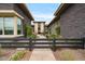 Inviting courtyard with stone pavers, lush greenery, and modern water features leading to the home's entrance at 19726 E Vallejo St, Queen Creek, AZ 85142