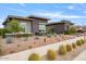 Beautiful front yard with desert landscaping, manicured bushes, and a walkway leading to the home's entrance at 19726 E Vallejo St, Queen Creek, AZ 85142