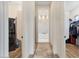 Hallway with washer and dryer leading to a stylish bathroom with modern finishes at 19726 E Vallejo St, Queen Creek, AZ 85142