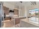 Spacious open kitchen with modern appliances, an island, and designer lighting at 19726 E Vallejo St, Queen Creek, AZ 85142