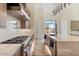 Modern kitchen features stainless steel appliances, marble countertops, and an island with a sink at 19726 E Vallejo St, Queen Creek, AZ 85142