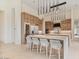 Modern kitchen with wine fridge, stainless steel appliances, and large central island with bar stool seating at 19726 E Vallejo St, Queen Creek, AZ 85142