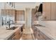 Modern kitchen features custom cabinets, stainless steel appliances, and marble countertops at 19726 E Vallejo St, Queen Creek, AZ 85142