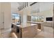 Spacious kitchen features a large island with marble countertops and contemporary pendant lighting at 19726 E Vallejo St, Queen Creek, AZ 85142