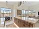 Bright kitchen boasts an island with marble countertop and seamless access to outdoor living spaces at 19726 E Vallejo St, Queen Creek, AZ 85142