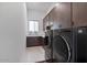 Well-equipped laundry room featuring modern appliances, ample cabinet space, and stylish decor at 19726 E Vallejo St, Queen Creek, AZ 85142
