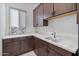 Functional laundry room with sleek countertops, ample storage, and modern fixtures at 19726 E Vallejo St, Queen Creek, AZ 85142