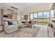 Open-concept living space boasts modern lighting, comfortable seating, and access to a lush backyard at 19726 E Vallejo St, Queen Creek, AZ 85142