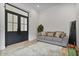 Bright living room with large windows, a gray sofa, and a decorative rug at 19726 E Vallejo St, Queen Creek, AZ 85142