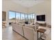 Expansive living room with a large sectional sofa, seamless backyard views, and modern decor at 19726 E Vallejo St, Queen Creek, AZ 85142