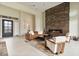 The living room showcases a floor-to-ceiling fireplace, large windows, and modern furniture at 19726 E Vallejo St, Queen Creek, AZ 85142