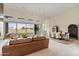 A spacious living room features a dining area with a large sliding glass door and a leather sofa at 19726 E Vallejo St, Queen Creek, AZ 85142