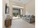 Contemporary living room with a view of the outdoor patio, a sleek entertainment center, and a gray sofa at 19726 E Vallejo St, Queen Creek, AZ 85142