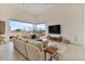 Bright living room features a large sofa, seamless indoor-outdoor flow, and a modern entertainment center at 19726 E Vallejo St, Queen Creek, AZ 85142