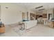 Open-concept living room featuring tile floors, a modern sofa, and seamless flow into the kitchen at 19726 E Vallejo St, Queen Creek, AZ 85142