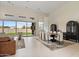 This spacious living room features a dining area with a sliding glass door and a leather sofa at 19726 E Vallejo St, Queen Creek, AZ 85142