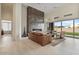 The bright living room features a floor to ceiling fireplace, a large window, and modern furniture at 19726 E Vallejo St, Queen Creek, AZ 85142