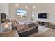 Bright and airy bedroom featuring wood floors, large windows, and a modern TV set at 19726 E Vallejo St, Queen Creek, AZ 85142