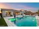 Inviting backyard pool with integrated spa and water feature, perfect for outdoor entertaining at twilight at 22421 N 34Th St, Phoenix, AZ 85050