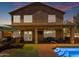 Beautiful backyard with a pool, covered patio, outdoor kitchen, and lush turf at 2635 W Angel Way, San Tan Valley, AZ 85144
